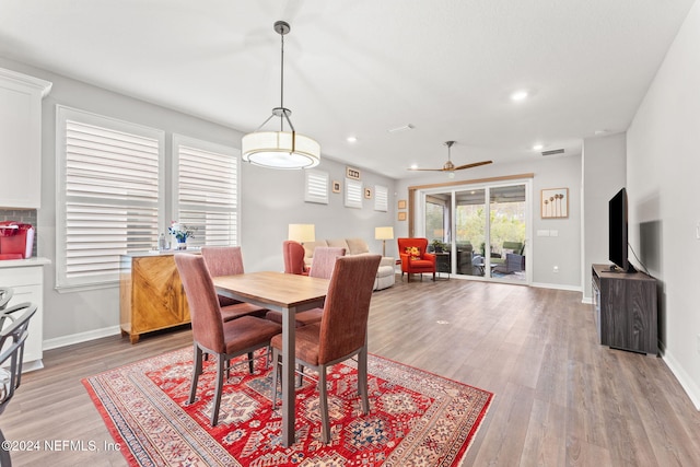 dining space featuring wood-type flooring and ceiling fan