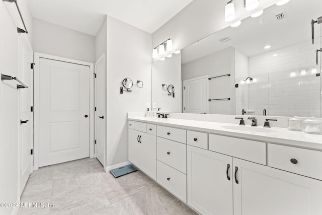 bathroom featuring vanity and a shower with shower door