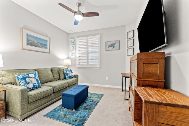 carpeted living room with ceiling fan