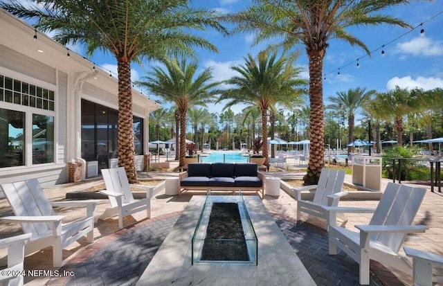 view of patio / terrace with a community pool and an outdoor fire pit