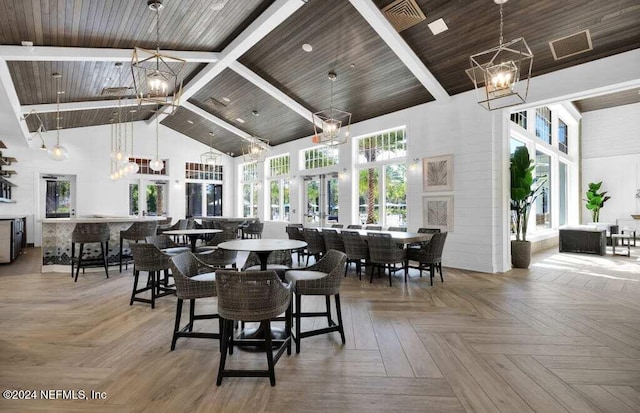 dining space featuring parquet flooring, high vaulted ceiling, beamed ceiling, and wood ceiling