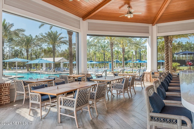 view of patio with ceiling fan and a community pool