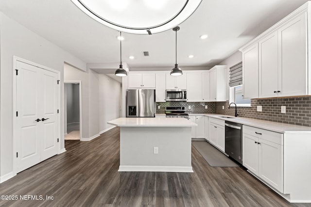 kitchen featuring backsplash, stainless steel appliances, and white cabinets