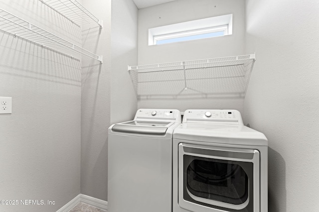 laundry room featuring washing machine and clothes dryer and laundry area