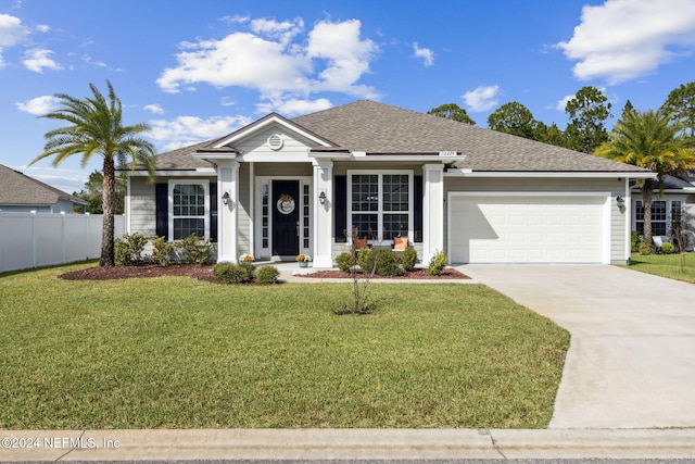 single story home with a front yard and a garage