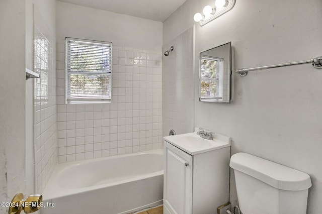 full bathroom featuring vanity, toilet, and tiled shower / bath