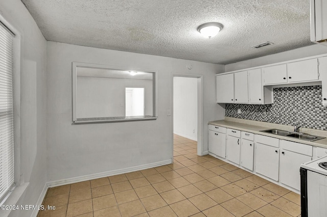 kitchen featuring white cabinets, white range with electric cooktop, sink, decorative backsplash, and light tile patterned flooring