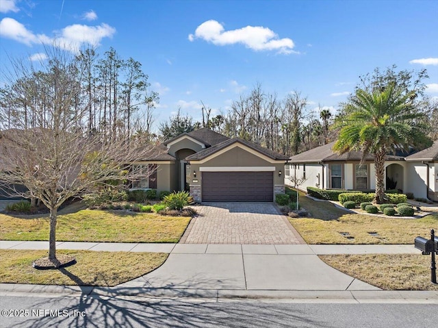 view of front facade with a garage and a front lawn