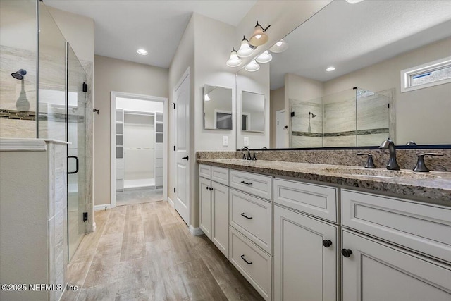 bathroom featuring vanity, a shower with shower door, and hardwood / wood-style floors