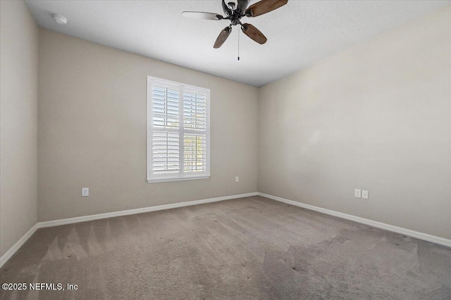 unfurnished room featuring ceiling fan and carpet