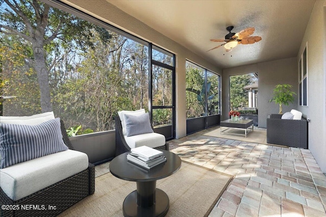 sunroom featuring ceiling fan