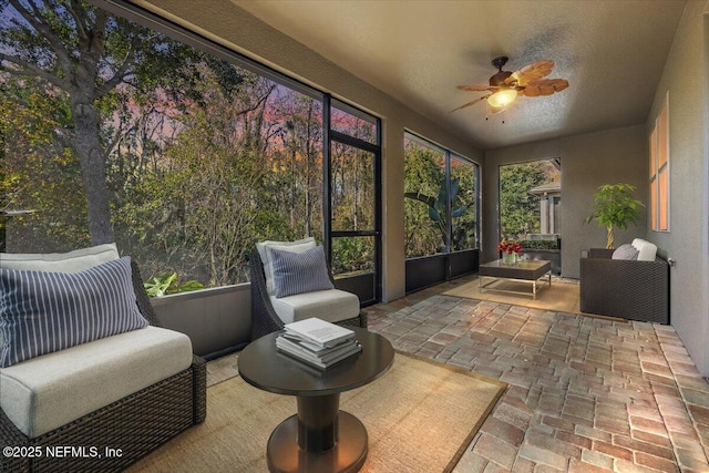 sunroom / solarium featuring ceiling fan