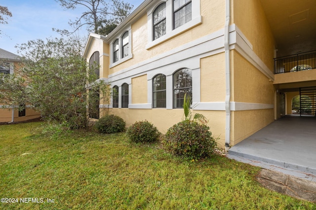 view of property exterior with a lawn