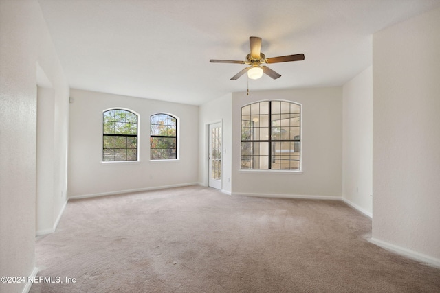 carpeted empty room with ceiling fan