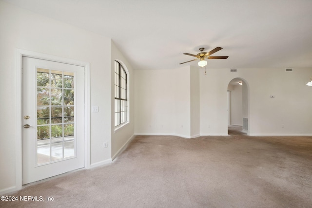 unfurnished room with ceiling fan and light colored carpet