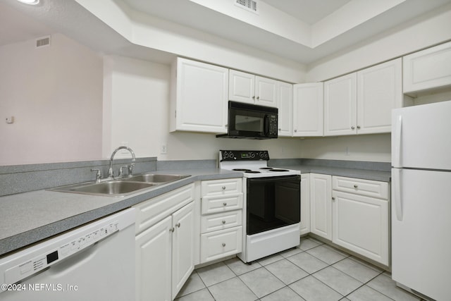 kitchen featuring white cabinets, white appliances, light tile patterned flooring, and sink