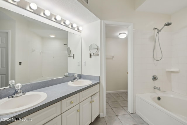 bathroom with tile patterned flooring, vanity, and tiled shower / bath combo