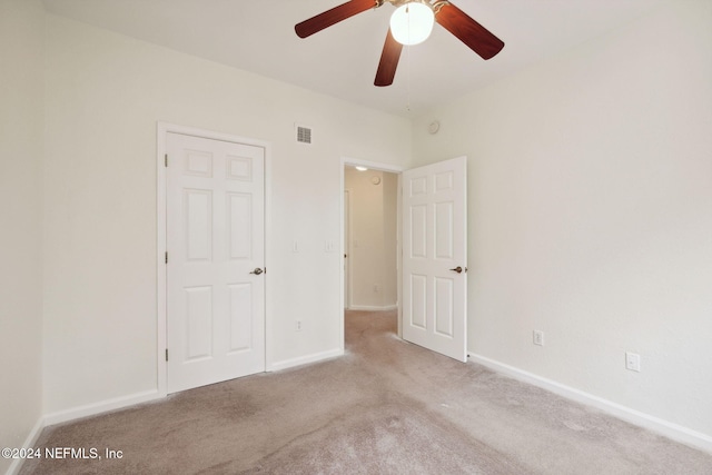 unfurnished bedroom featuring light colored carpet and ceiling fan