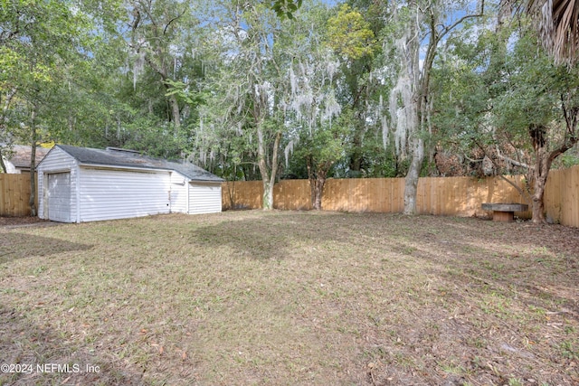 view of yard with a garage and an outdoor structure