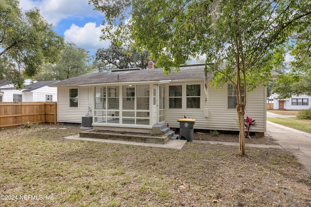 back of house featuring a sunroom