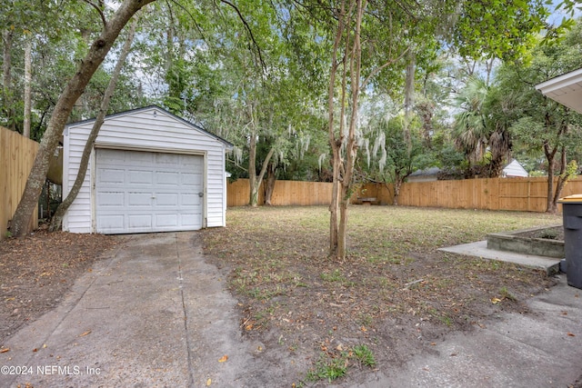 view of yard with a garage and an outdoor structure