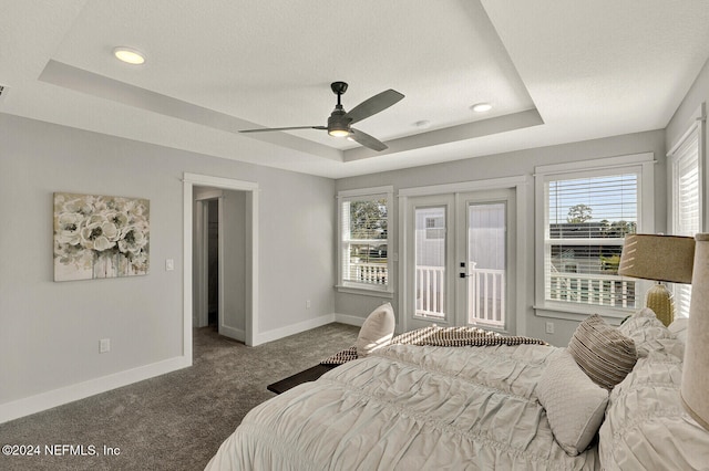 carpeted bedroom with a raised ceiling, ceiling fan, french doors, and access to outside