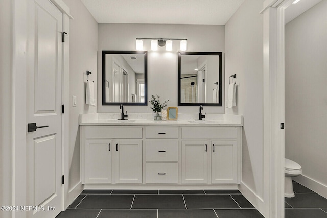 bathroom with tile patterned floors, vanity, and toilet