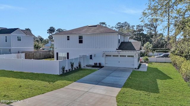 view of front of home with a front lawn and a garage