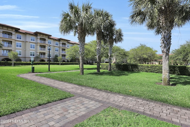 view of property's community with a lawn