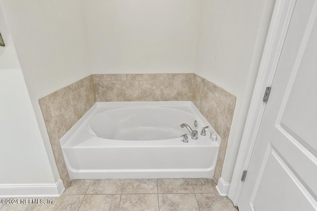 bathroom featuring a washtub and tile patterned flooring