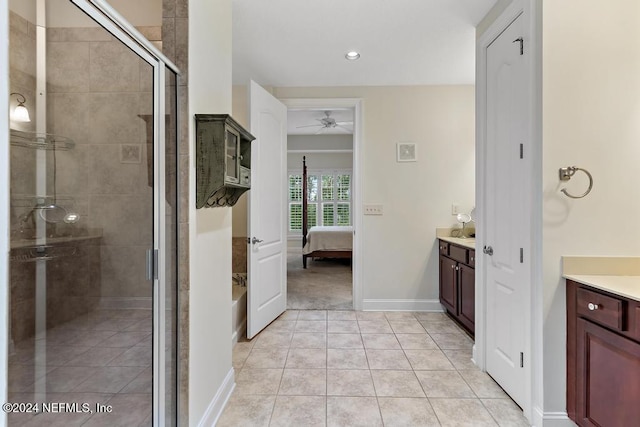 bathroom with tile patterned floors, ceiling fan, vanity, and plus walk in shower