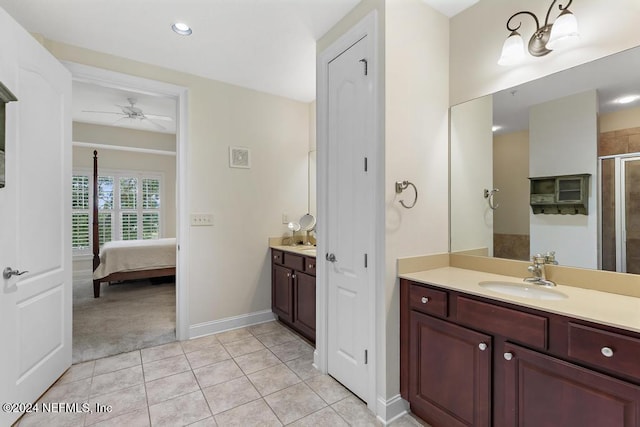 bathroom with ceiling fan, tile patterned flooring, vanity, and a shower with shower door