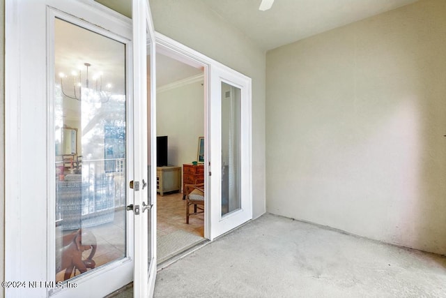 interior space with a chandelier and french doors