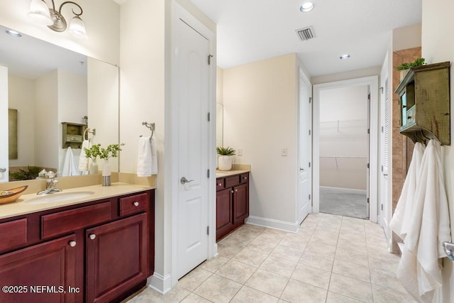 bathroom with tile patterned floors and vanity