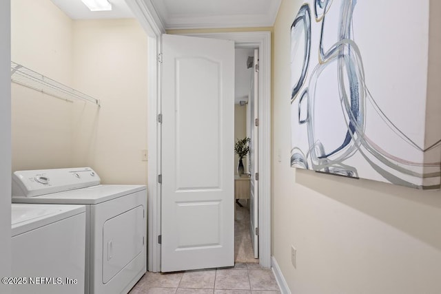 laundry area with ornamental molding, light tile patterned floors, and washer and clothes dryer