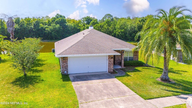 view of front of property with a garage and a front lawn