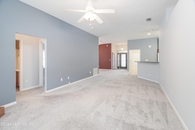 unfurnished living room featuring ceiling fan and light colored carpet