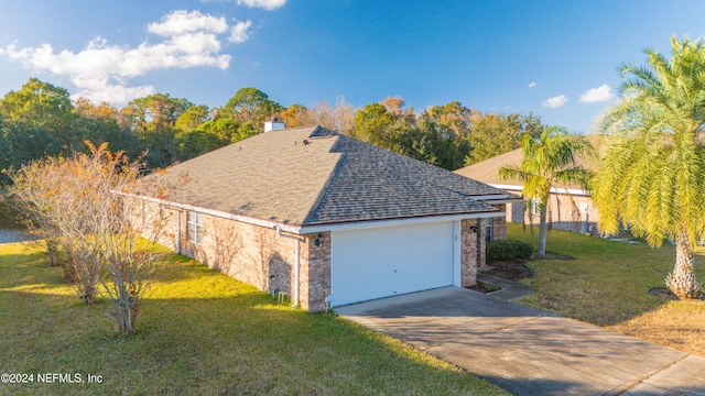 view of side of property with a garage and a lawn