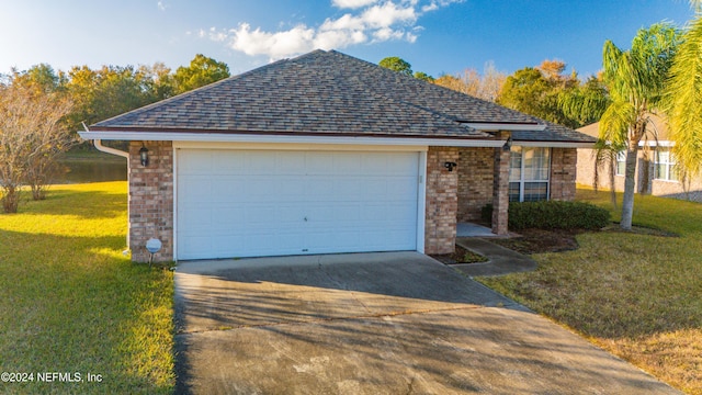 view of front of house with a garage and a front lawn