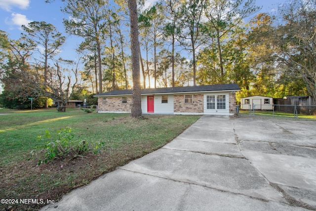 ranch-style home with a front lawn