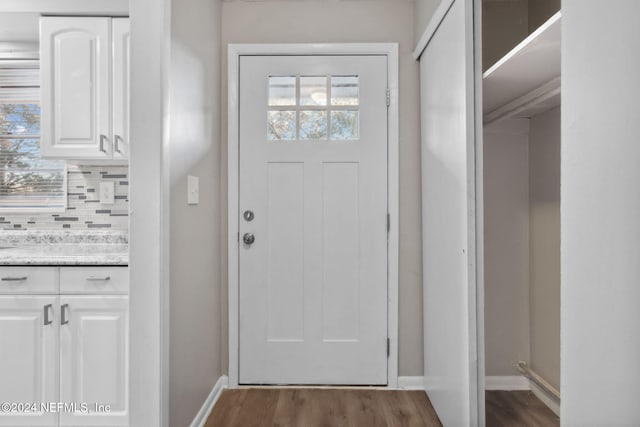 doorway with dark hardwood / wood-style flooring