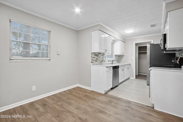 kitchen with appliances with stainless steel finishes, backsplash, ornamental molding, white cabinets, and light hardwood / wood-style floors