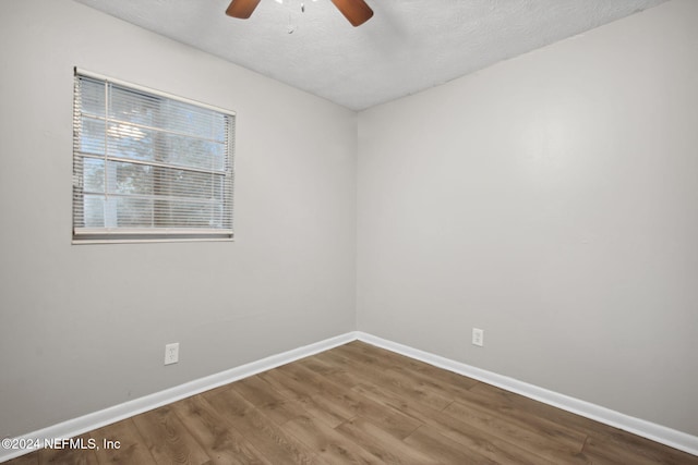 unfurnished room with hardwood / wood-style floors, a textured ceiling, and ceiling fan