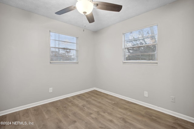 spare room featuring a textured ceiling, hardwood / wood-style flooring, and ceiling fan