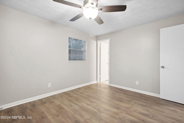 spare room featuring ceiling fan, a textured ceiling, and hardwood / wood-style flooring