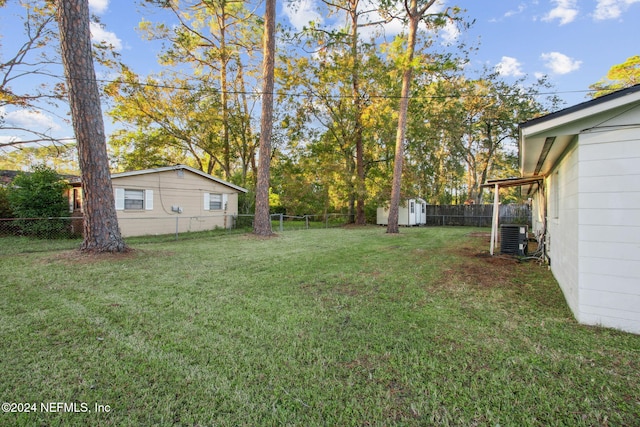 view of yard with a shed and central AC unit