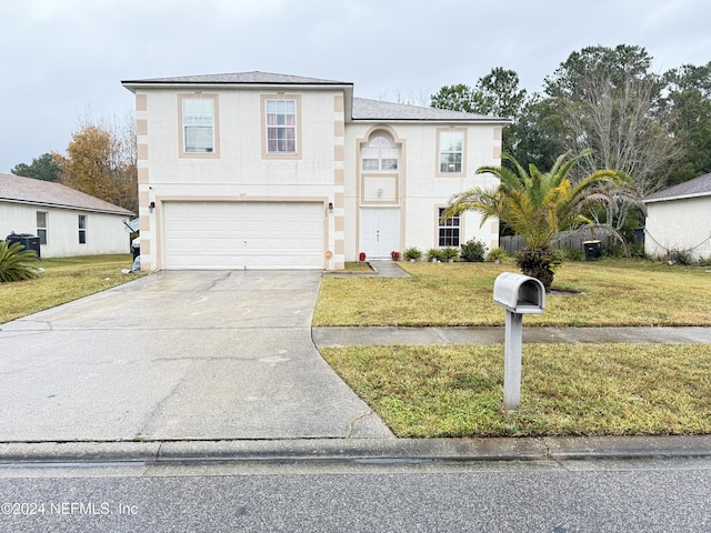 view of front of house featuring a front lawn and a garage