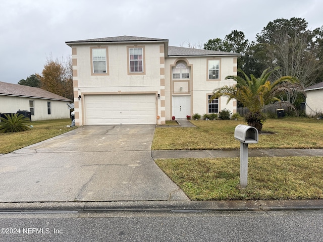 view of front facade with a garage and a front yard