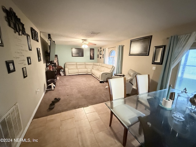 living room with light carpet and ceiling fan