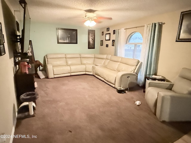 carpeted living room with ceiling fan and a textured ceiling